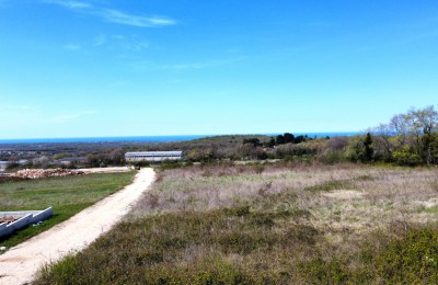 Building plot with building permit, sea view, and paid utility fees.